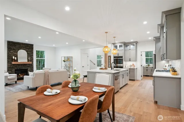 a open dining room with furniture and wooden floor