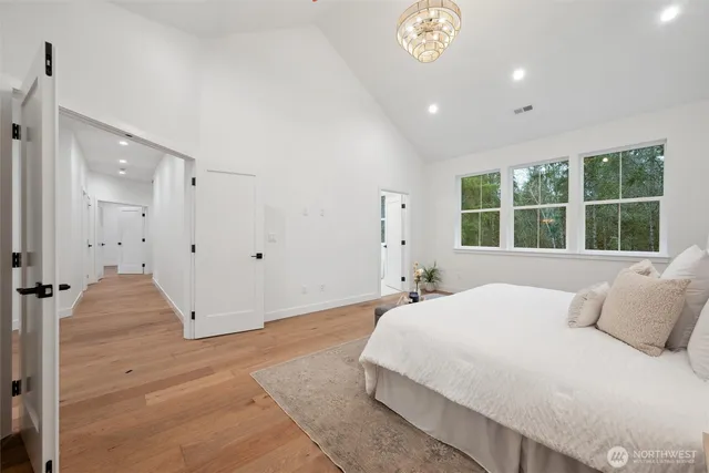 a bedroom with a large bed and a large window