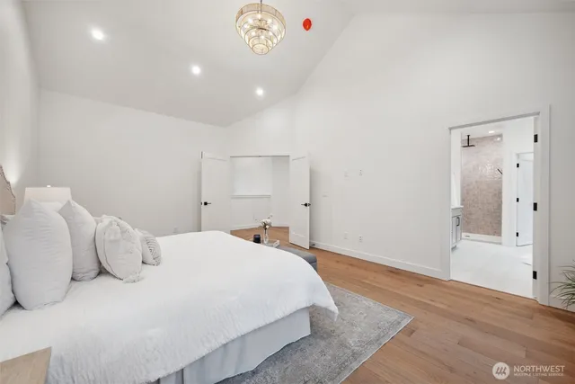 a bedroom with a bed and a chandelier