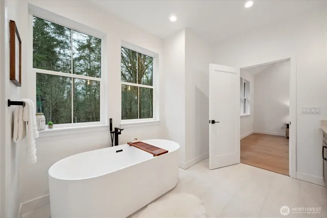 a bathroom with a tub and a sink