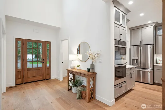 a kitchen with stainless steel appliances granite countertop a refrigerator and a sink