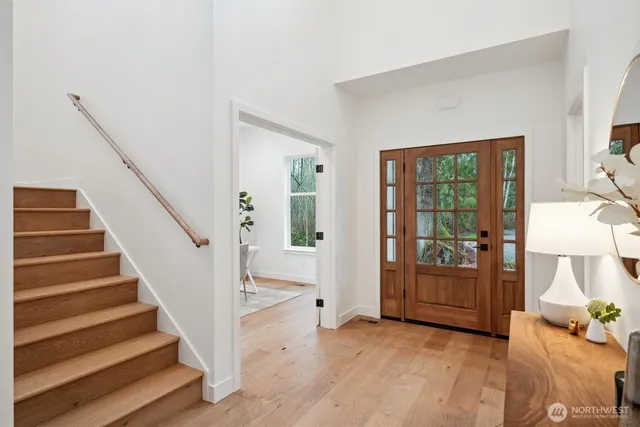 a view of entryway and hall with wooden floor
