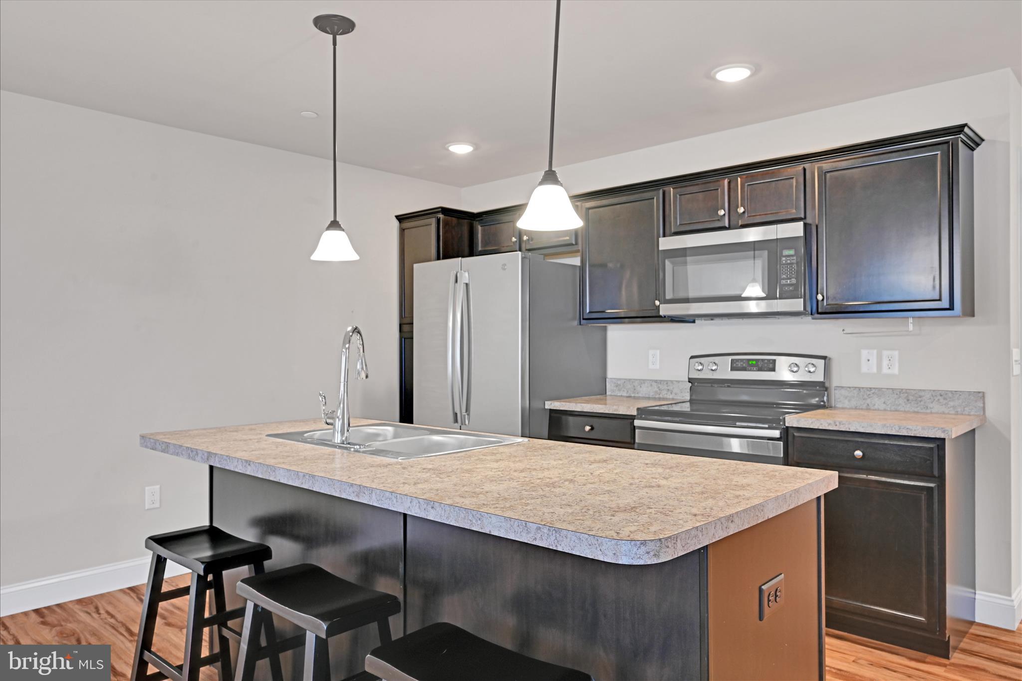362 Cedar Hollow Manheim, PA 17545 - Photo 11 of 34 a kitchen with stainless steel appliances granite countertop a kitchen island a stove and a sink