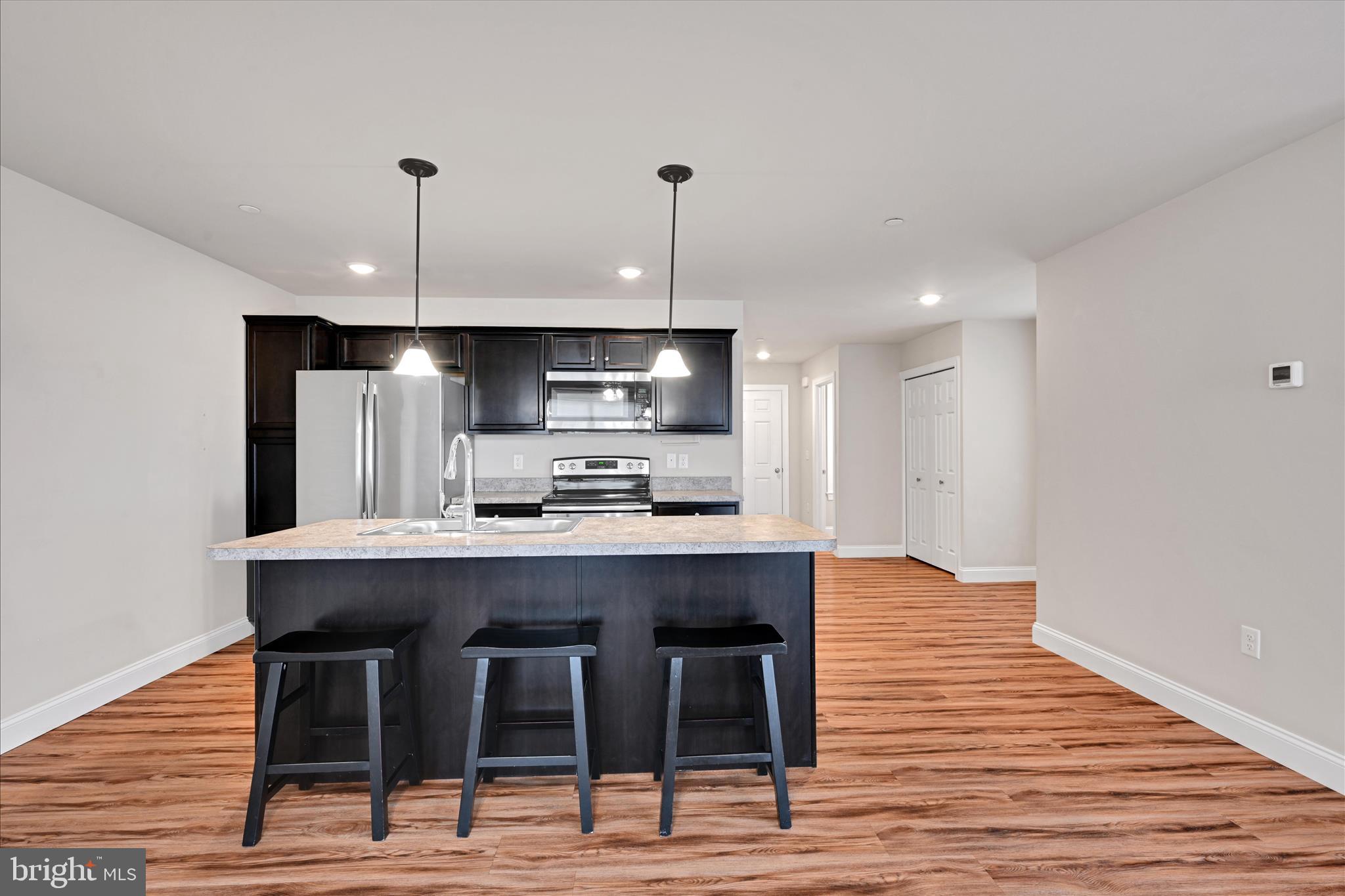 362 Cedar Hollow Manheim, PA 17545 - Photo 12 of 34 a kitchen with stainless steel appliances a dining table chairs and wooden floor