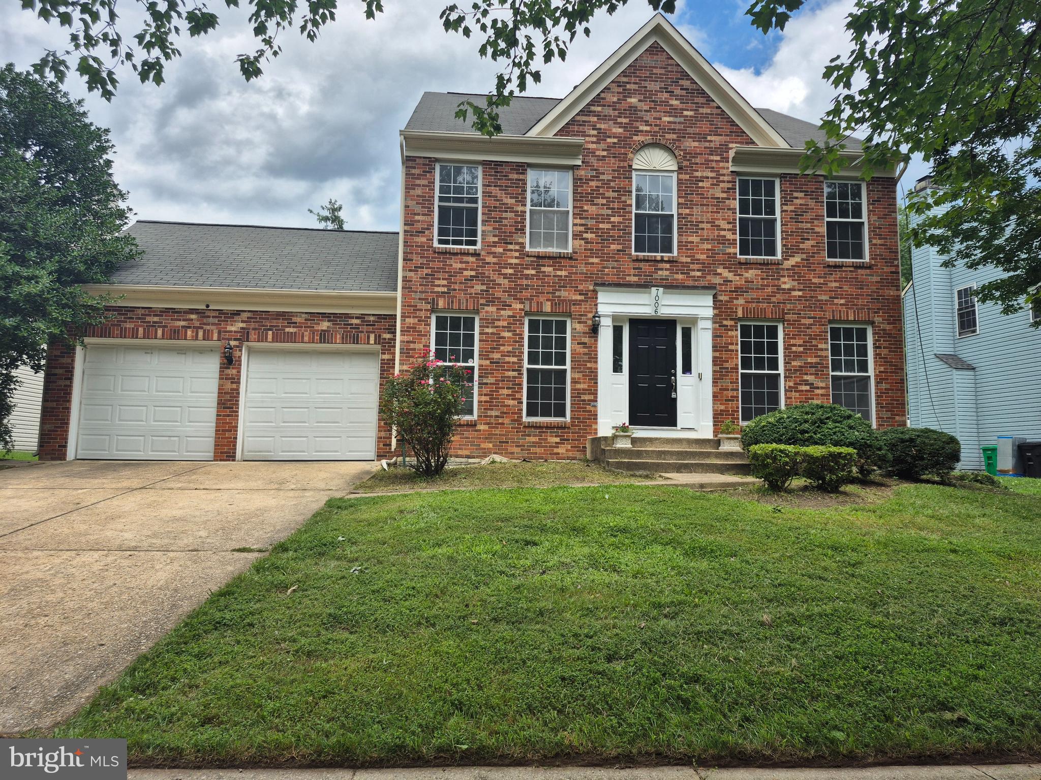 7006 Chain Fern Court Clinton, MD 20735 - Photo 1 of 23 a front view of a house with a yard and garage