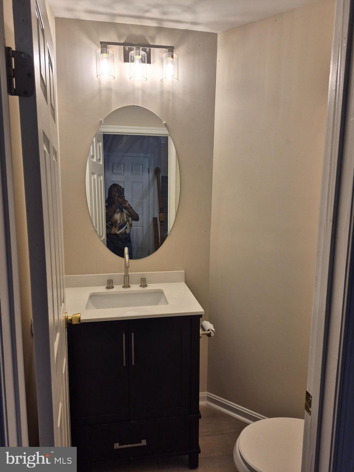 7006 Chain Fern Court Clinton, MD 20735 - Photo 5 of 23 a bathroom with a toilet sink and mirror