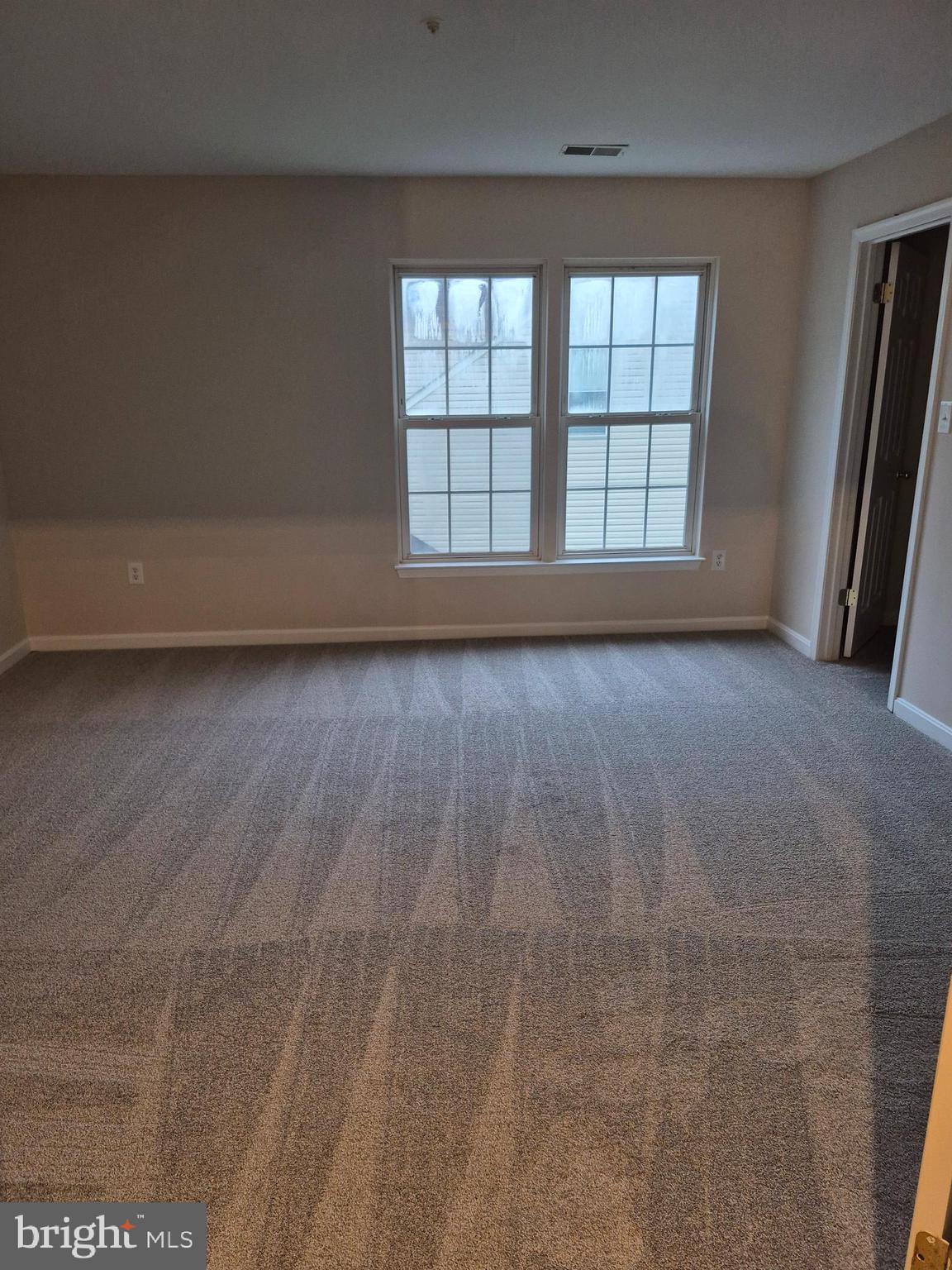 7006 Chain Fern Court Clinton, MD 20735 - Photo 6 of 23 an empty room with wooden floor and windows