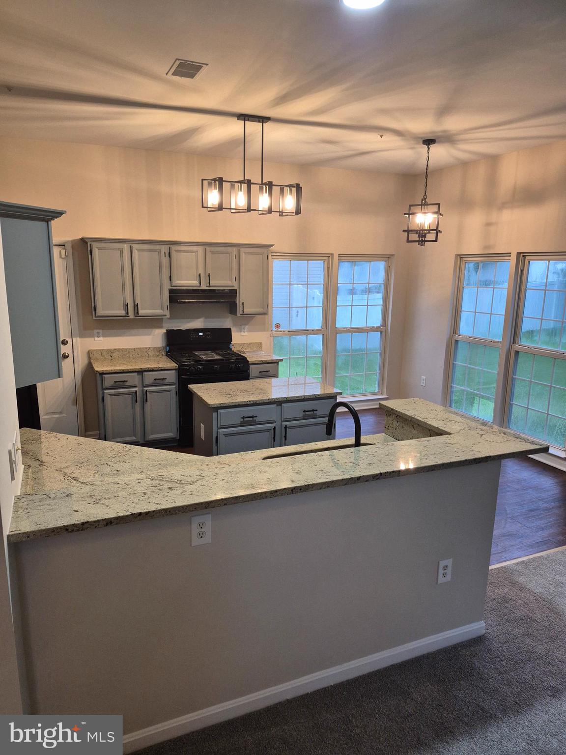 7006 Chain Fern Court Clinton, MD 20735 - Photo 7 of 23 a kitchen with stainless steel appliances granite countertop a sink a stove top oven a counter space and cabinets