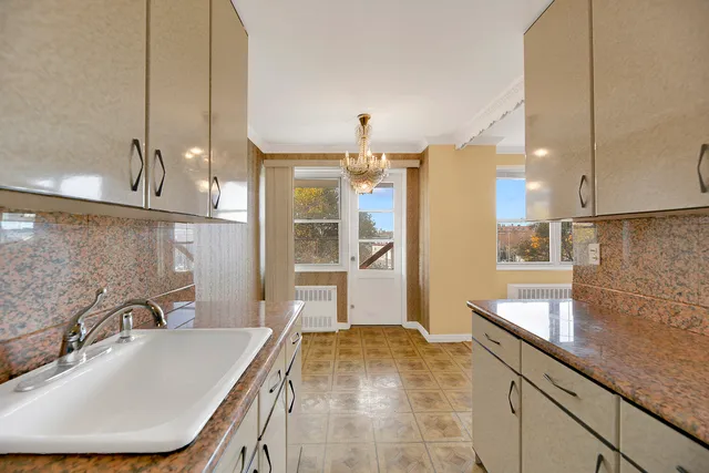 a bathroom with a granite countertop sink a mirror and a shower