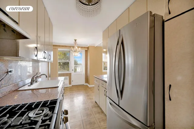 a kitchen with stainless steel appliances granite countertop a refrigerator and a sink