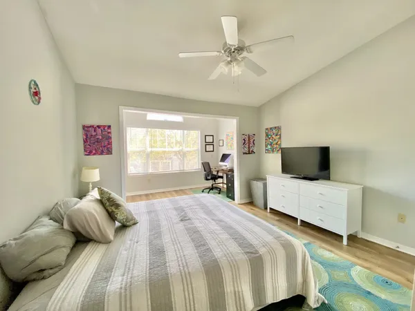 a bedroom with a bed and flat screen tv