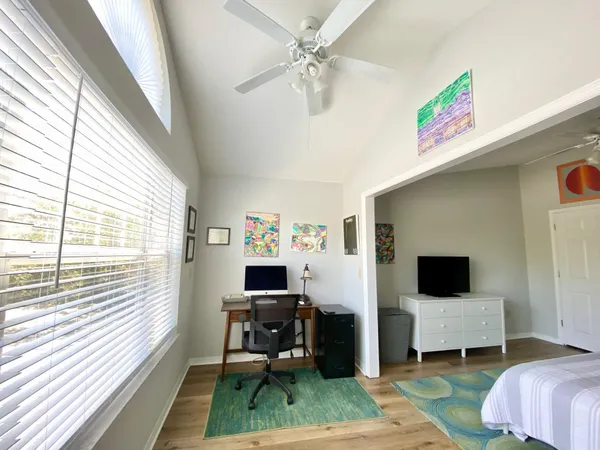 a view of a livingroom with workspace and a window