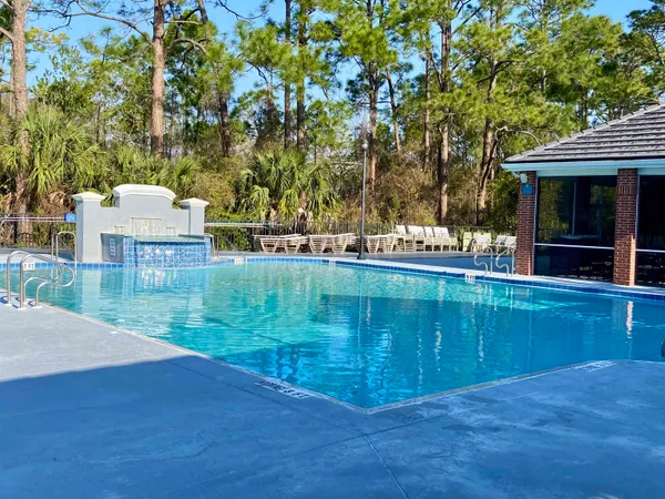 swimming pool view with a seating space