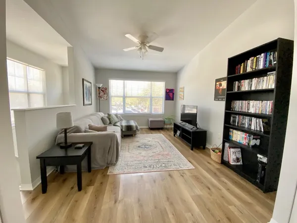a living room with furniture and a book shelf