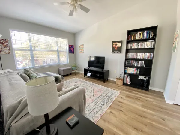 a living room with furniture cabinets and a window