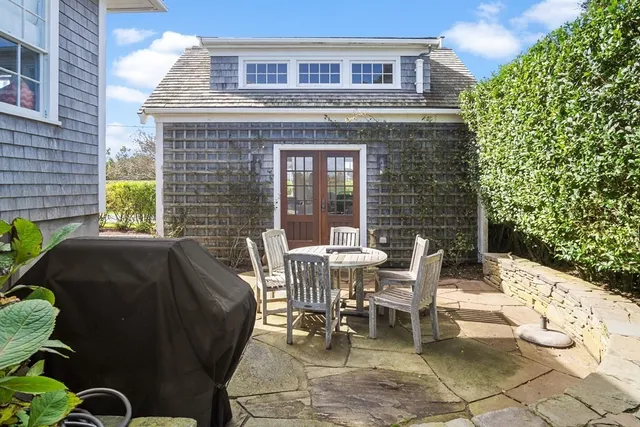 a view of a patio with table and chairs and potted plants