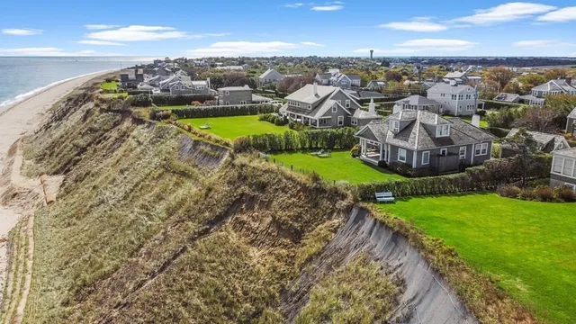 an aerial view of residential houses with outdoor space and river