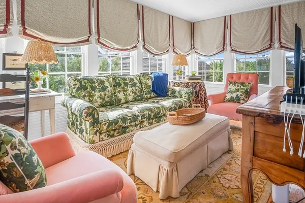 a living room with furniture fireplace and a mirror