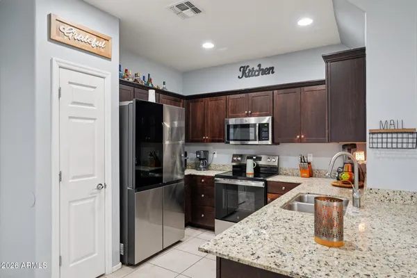 a living room with lots of furniture and kitchen view