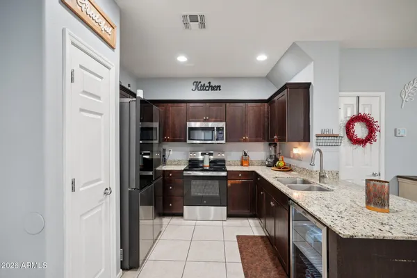 a kitchen with granite countertop a sink and white appliances