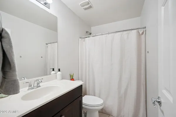 a kitchen with stainless steel appliances kitchen island granite countertop a refrigerator and a stove top oven