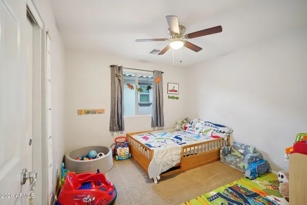 a bathroom with a sink a toilet a mirror and shower curtain