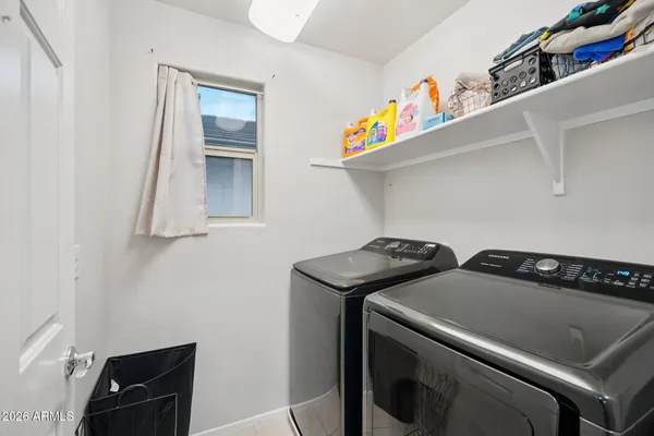 a bedroom with a bed couch and a window