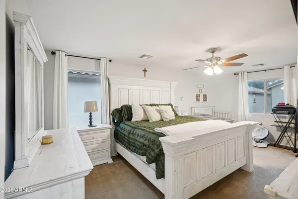 a bedroom with a bed and a chandelier