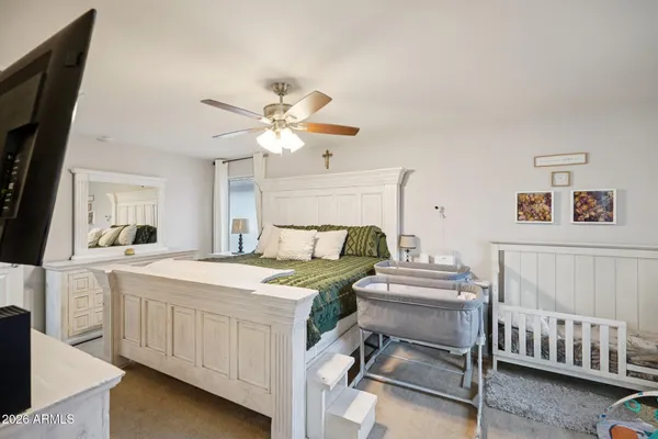 a bedroom with a bed and a chandelier