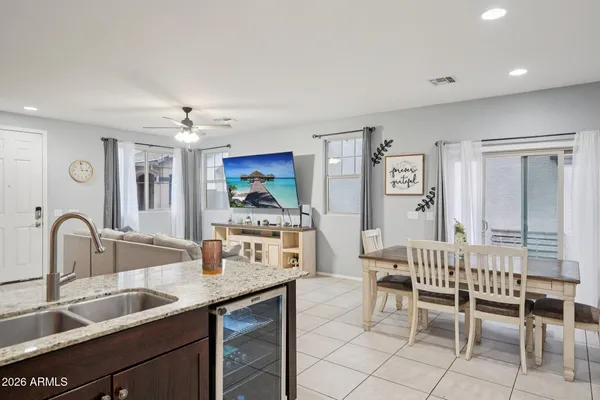 a living room with furniture and kitchen view
