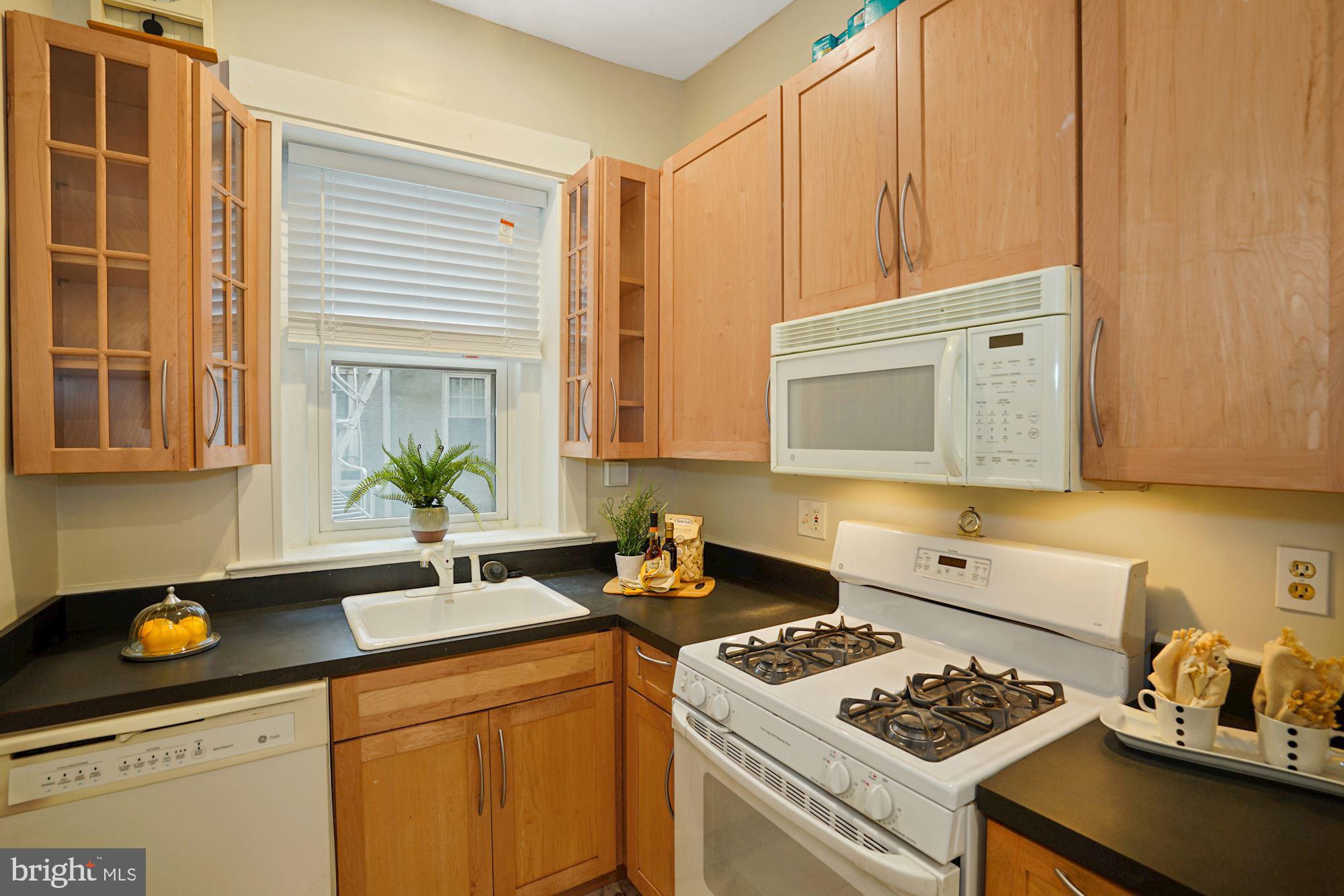 1322 15th Street Northwest, Unit 3 Washington, DC 20005 - Photo 13 of 16 a kitchen with a stove a sink and cabinets