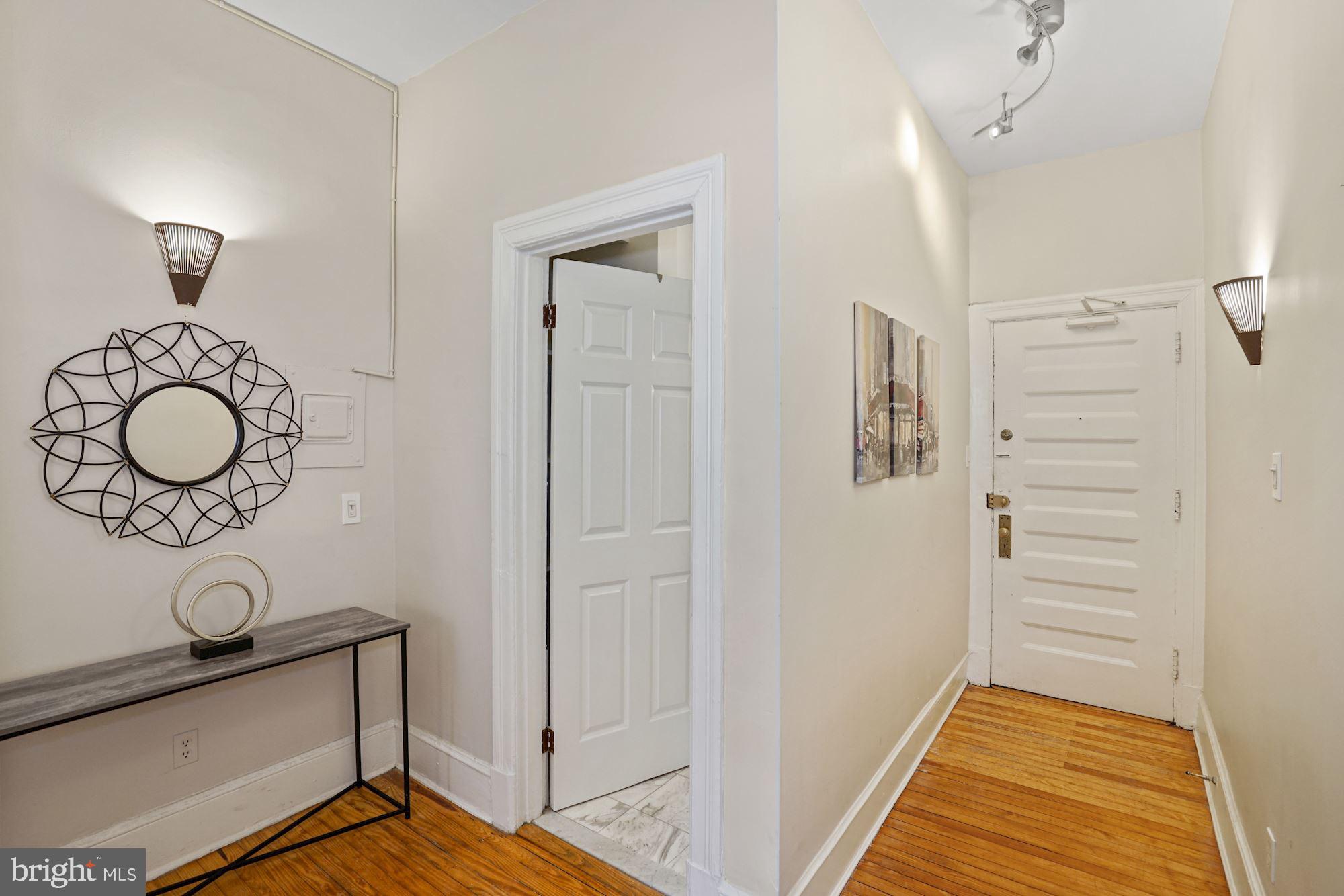 1322 15th Street Northwest, Unit 3 Washington, DC 20005 - Photo 4 of 16 a view of a hallway with wooden floor and staircase