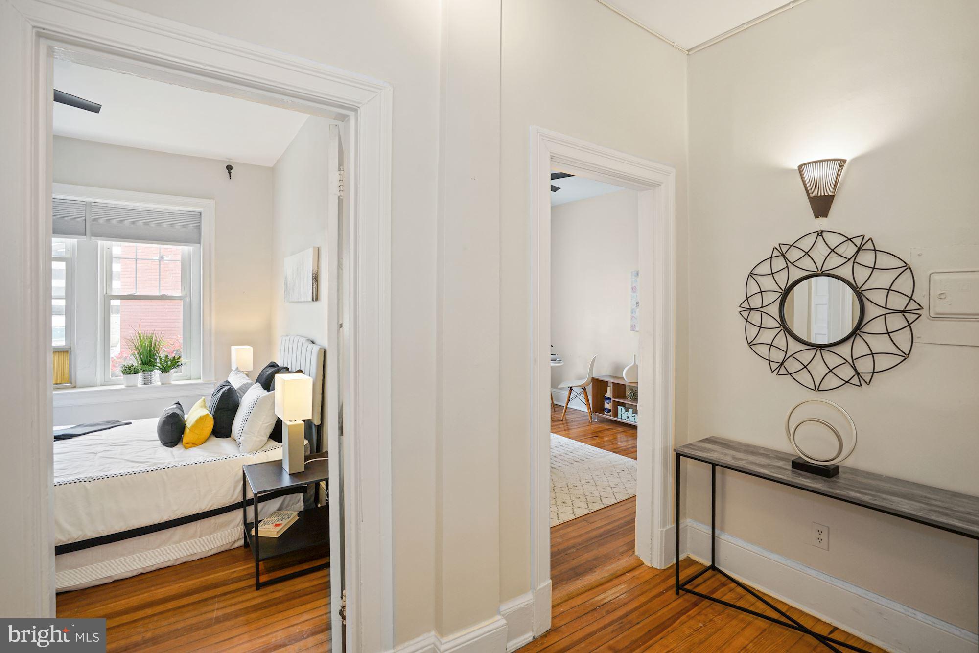 1322 15th Street Northwest, Unit 3 Washington, DC 20005 - Photo 5 of 16 a bedroom with a bed and wooden floor