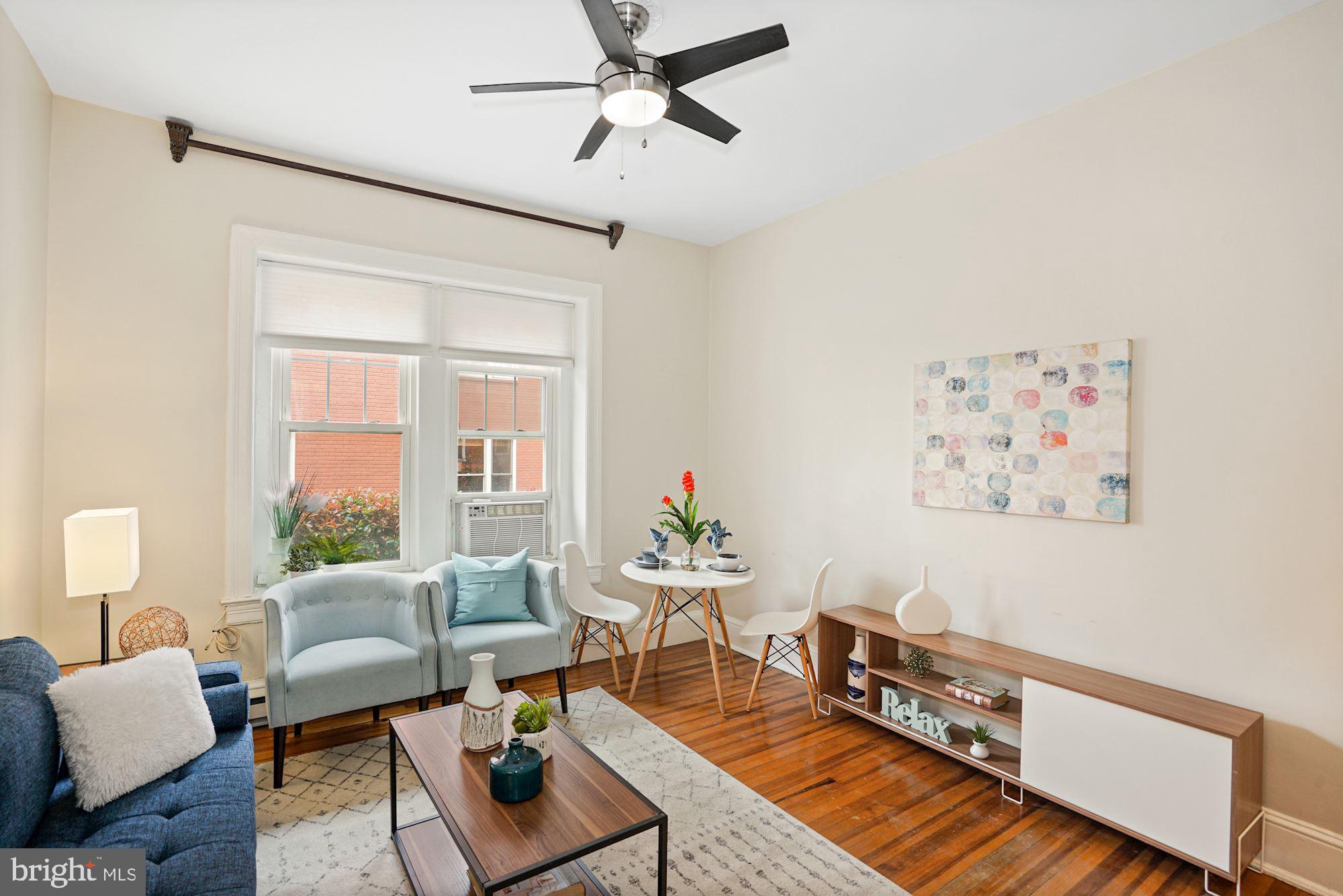 1322 15th Street Northwest, Unit 3 Washington, DC 20005 - Photo 6 of 16 a living room with furniture and a window