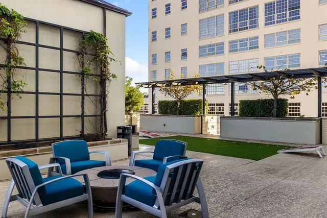 a view of a swimming pool with lawn chairs under an umbrella