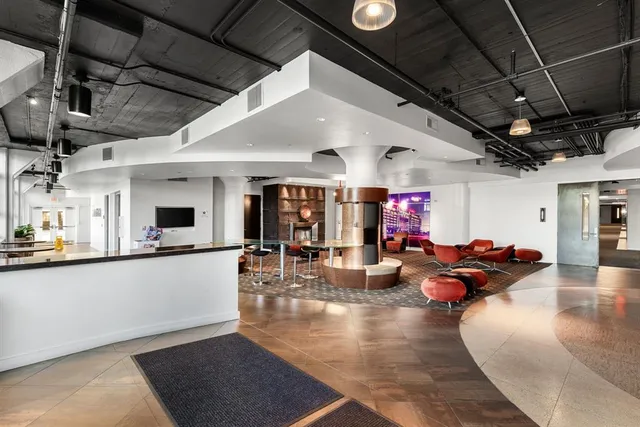 a living room with furniture a rug and a large window