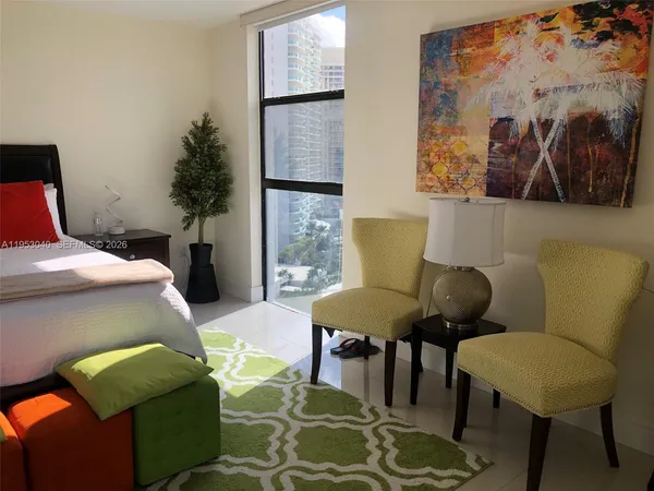 a bedroom with a bed and a chair