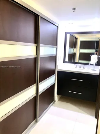 a bathroom with a double vanity sink and a mirror