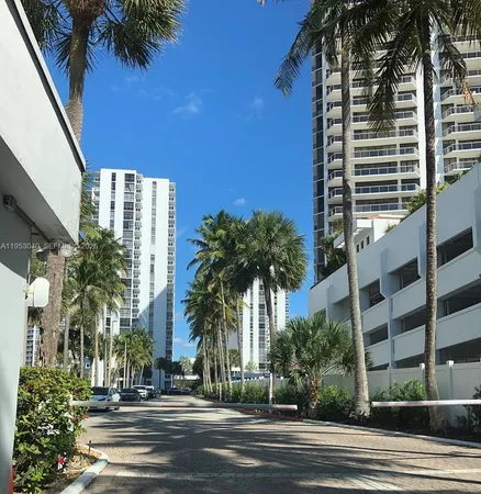 a view of a tall building next to a yard