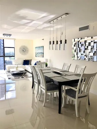 a view of a dining room with furniture and chandelier