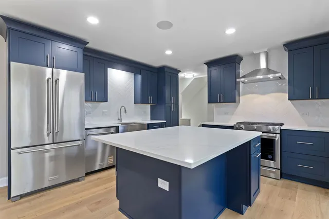 a kitchen with stainless steel appliances a refrigerator and a stove