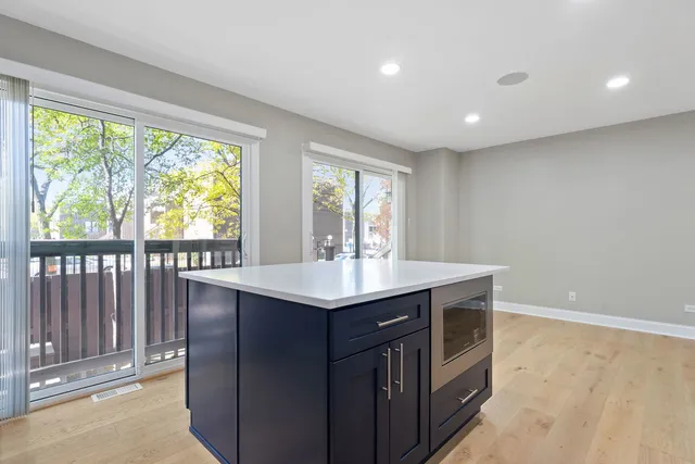 a kitchen with a sink and large window