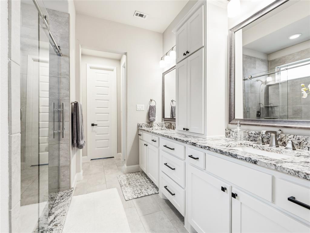 15340 Crape Myrtle Road Frisco, TX 75035 - Photo 22 of 40 Dual vanity with white cabinetry, speckled countertops, and undermount sinks