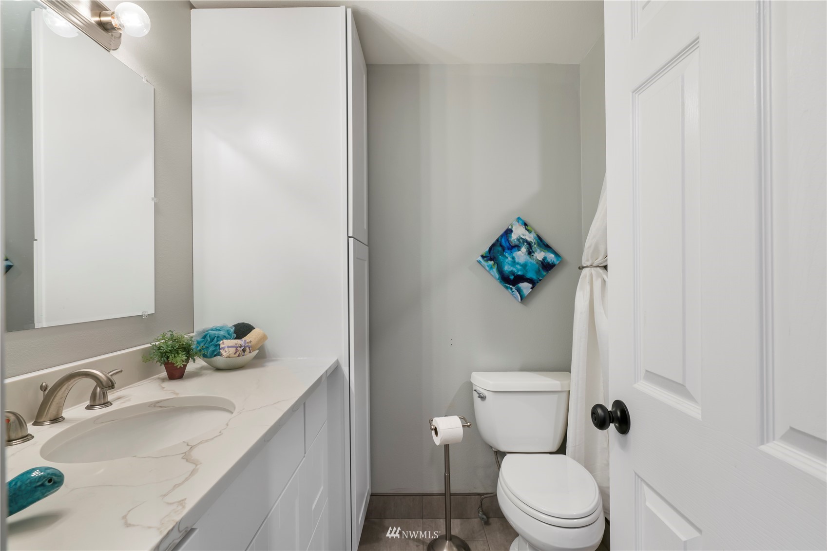 20104 103rd Place Northeast Bothell, WA 98011 - Photo 25 of 40 a bathroom with a granite countertop sink a toilet and a mirror