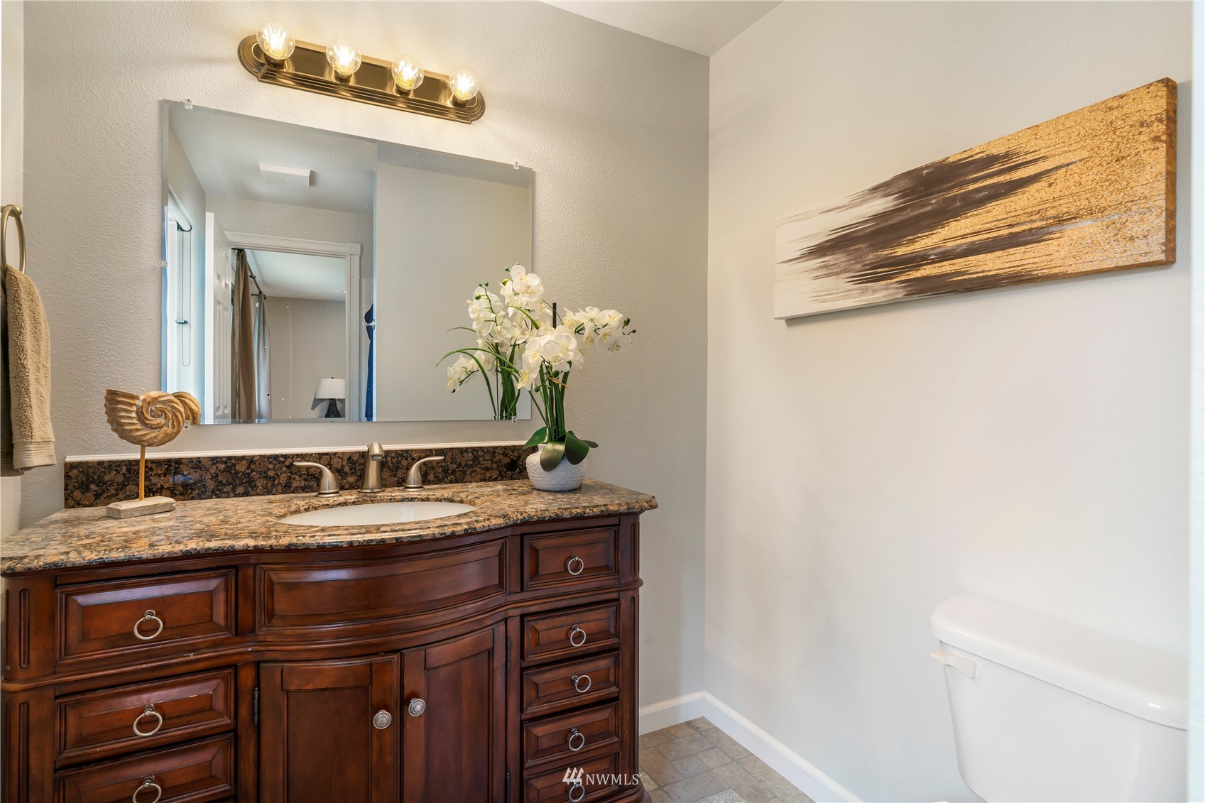 20104 103rd Place Northeast Bothell, WA 98011 - Photo 28 of 40 a bathroom with a granite countertop sink and a mirror