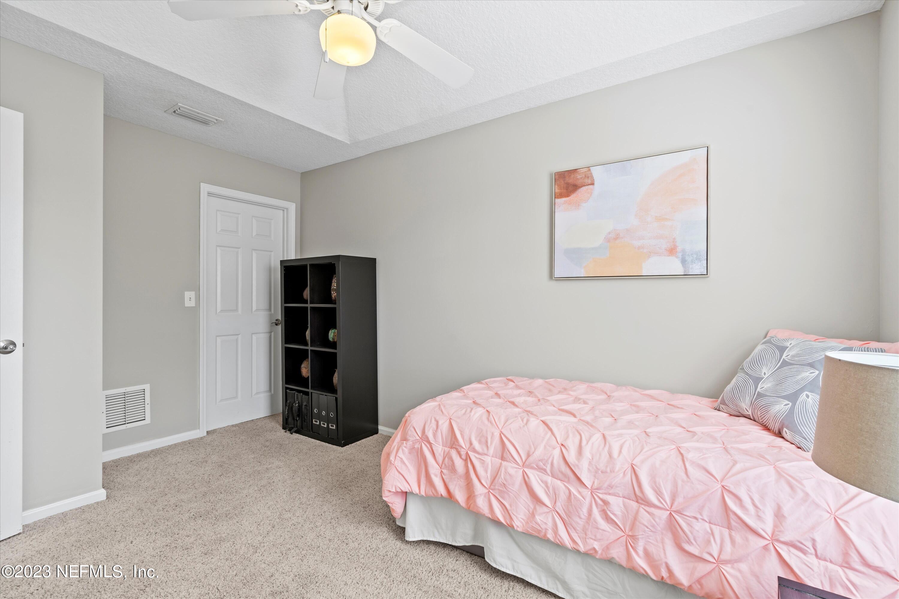 618 Racoon Court St. Johns, FL 32259 - Photo 27 of 61 a bedroom with a bed and a wall painting