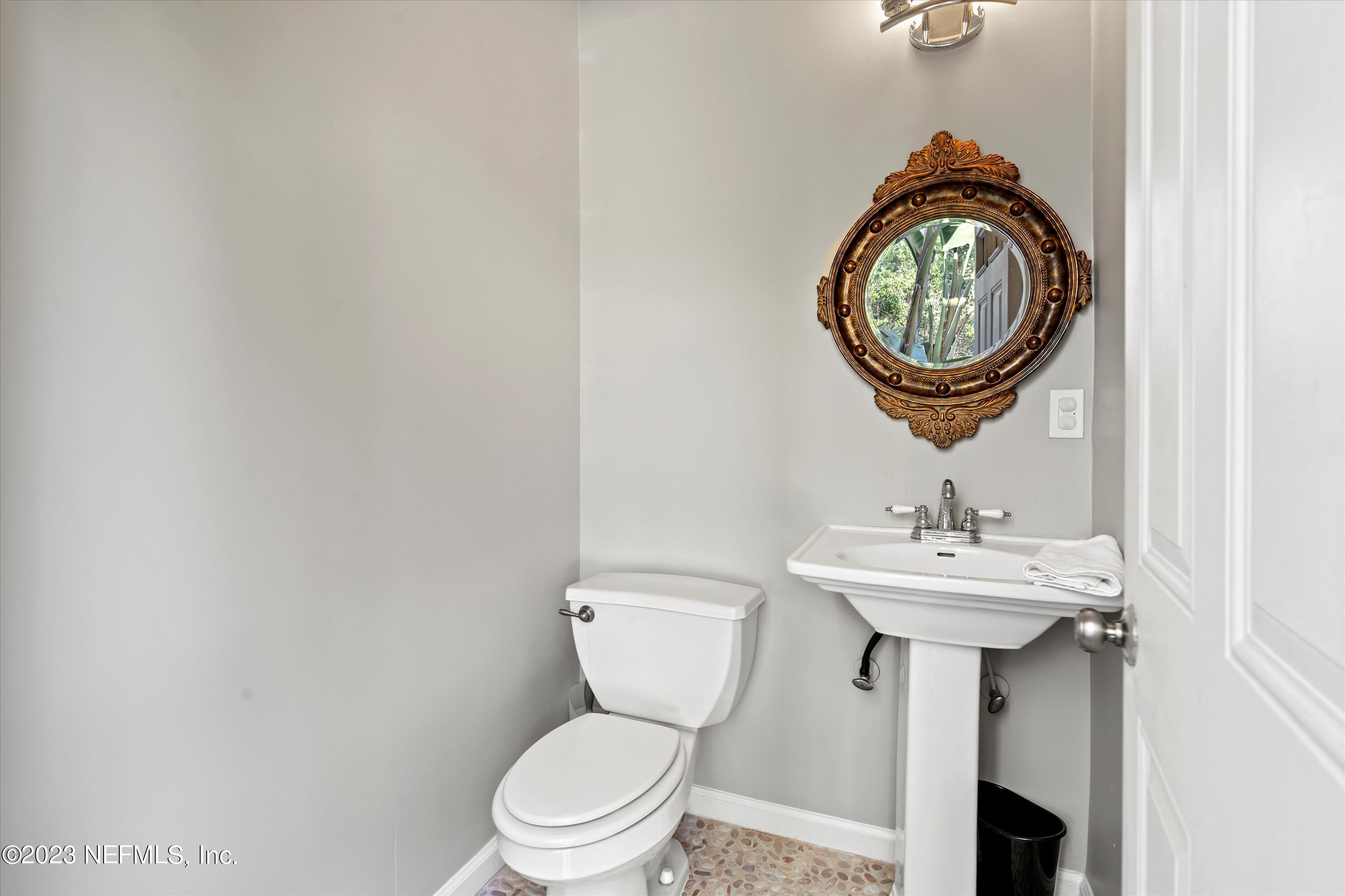 618 Racoon Court St. Johns, FL 32259 - Photo 36 of 61 a bathroom with a toilet a sink and a mirror