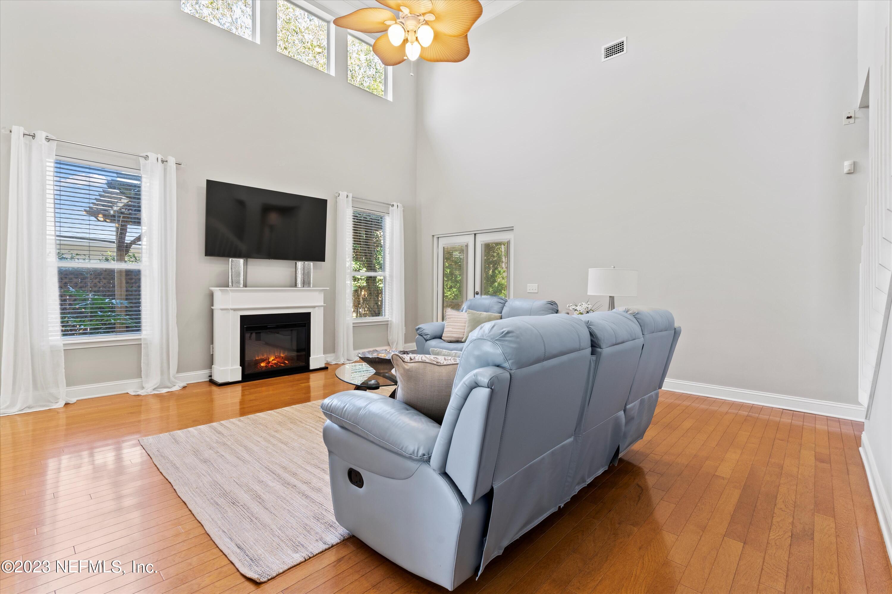 618 Racoon Court St. Johns, FL 32259 - Photo 8 of 61 a living room with furniture a flat screen tv and a fireplace