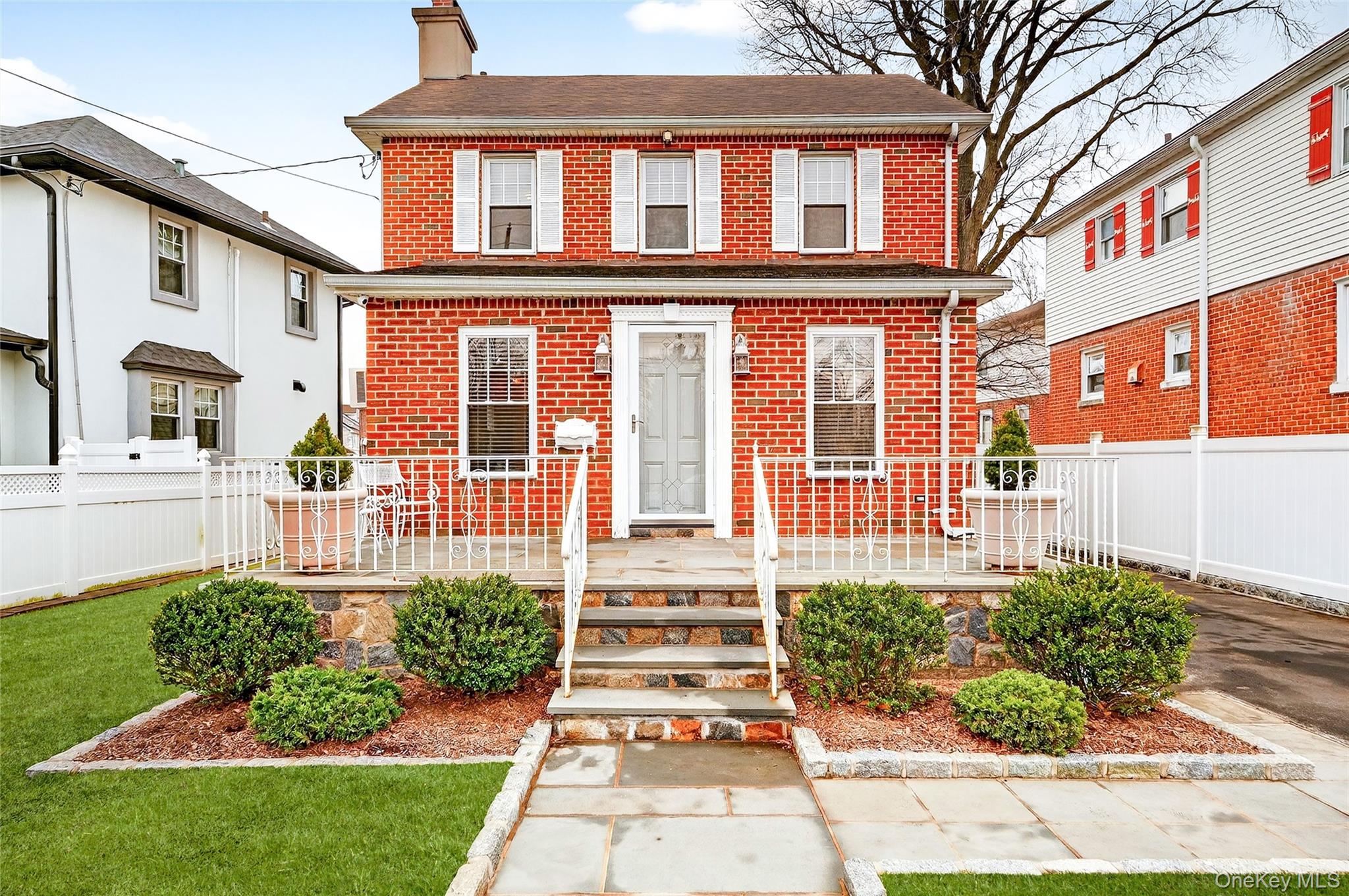 3334 Country Club Road Bronx, NY 10465 - Photo 2 of 48 front view of a brick house with a yard