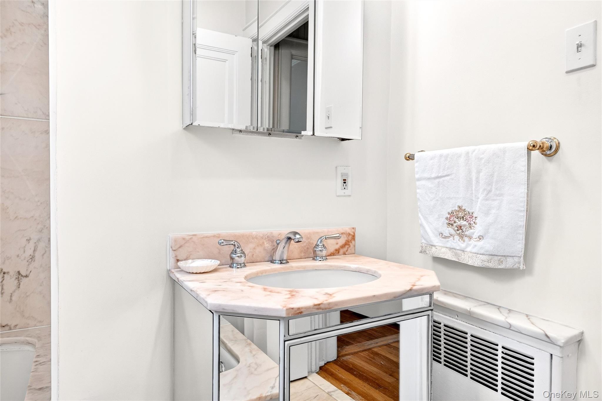 3334 Country Club Road Bronx, NY 10465 - Photo 41 of 48 a bathroom with a sink and a mirror